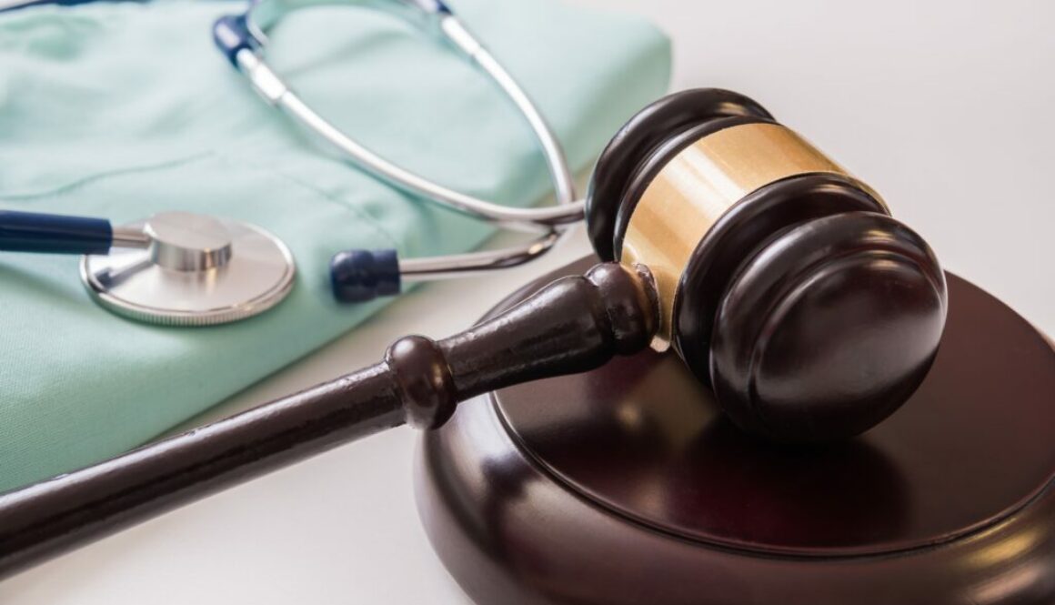 Gavel and stethoscope in background. Medical laws and legal conc
